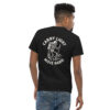 Man wearing a black Varbridge t-shirt with a bold white back graphic of a skeleton carrying a backpack, lantern, and trekking pole, surrounded by the phrase “CARRY LIGHT MOVE HARD.”