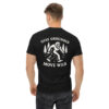 Man wearing a black t-shirt with a white back graphic of Bigfoot striding through pine trees, surrounded by the phrase “STAY GROUNDED MOVE WILD.”