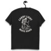 Black t-shirt hanging on a hook with a white graphic on the back showing a skeleton hiker carrying a backpack, lantern, and trekking pole, surrounded by the phrase “CARRY LIGHT MOVE HARD.”