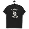 Black t-shirt hanging on a hook with bold white “Stay Sharp” graphic on the back, featuring a skull pierced by a combat knife through the temple