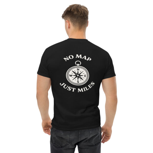 Man wearing a black Varbridge t-shirt with a white compass design on the back and the phrase “No Map Just Miles” arched above and below it