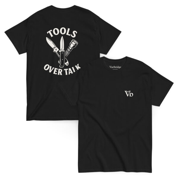 Black Varbridge t-shirt laid flat showing front and back—front features Vb logo on chest; back displays crossed knife, multi-tool, and flashlight graphic with “Tools Over Talk” text