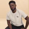 Man wearing Varbridge t-shirt with clean Vb chest logo, seated against neutral background